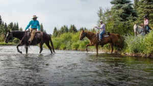 Riding a horse passing the private hot springs at 4UR Ranch